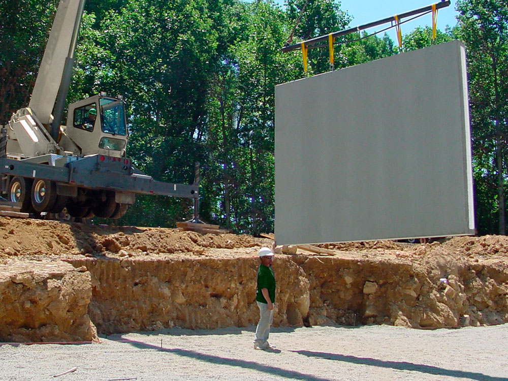 precast wall suspended over basemnt prep area