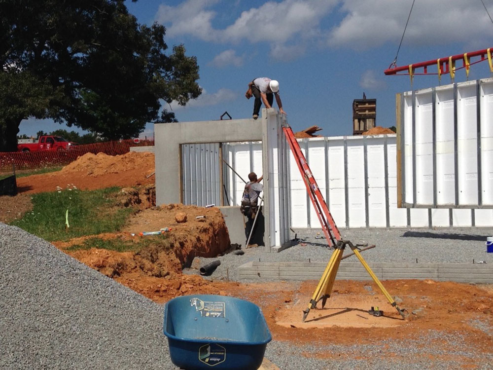 workers lining up precast walls